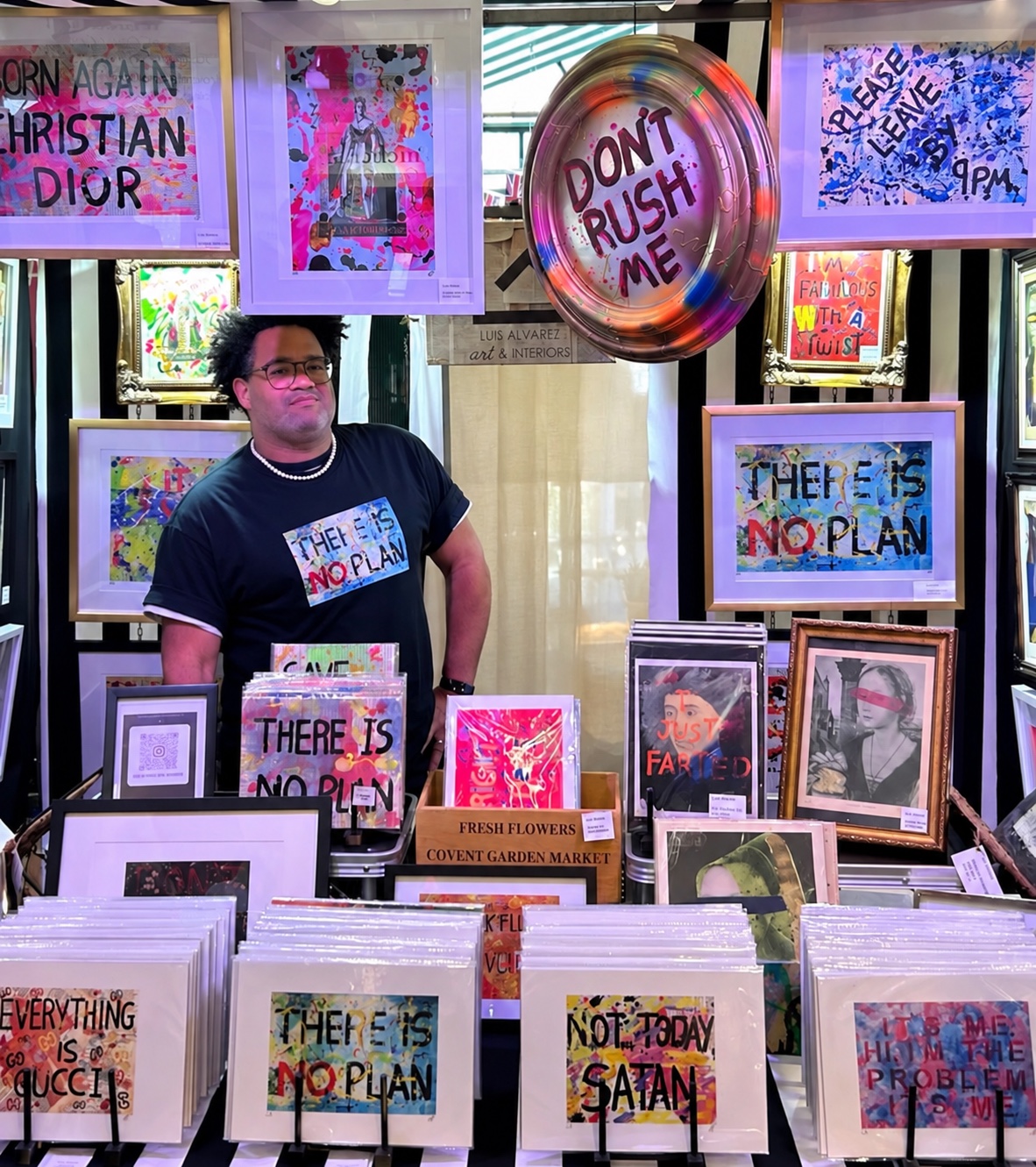 Luis Alvarez at his stall in Jubilee Market Hall, Covent Garden, surrounded by his hand-painted art